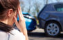 female looking at car collision