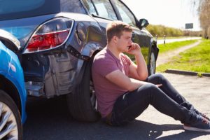Teen driver talking to a parent after a wreck