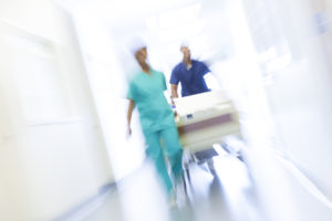 Time lapse image of nurses running down a hallway