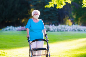 disabled woman with a walker, wearing a mask