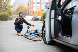 Accident between a bicycle and a car on the road