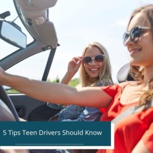 Two teenagers driving a car